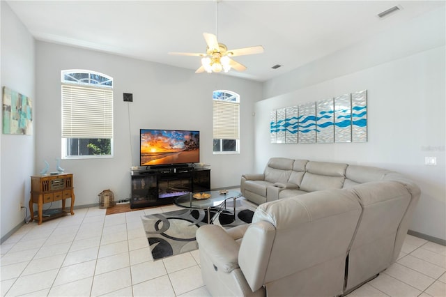 5211 Karlsburg Pl, Palm Harbor, FL 34685 - living area featuring light tile patterned floors, ceiling fan, and plenty of natural light