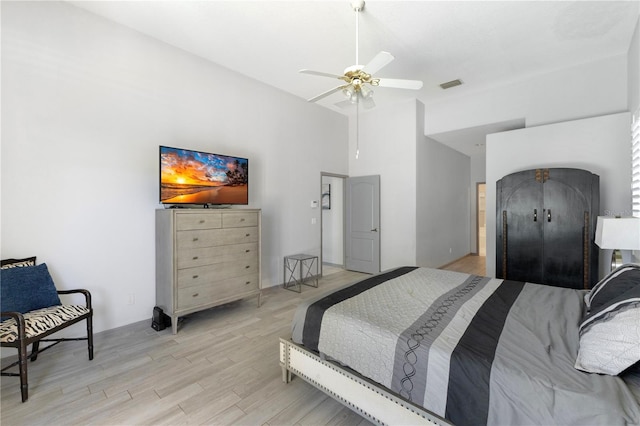 5211 Karlsburg Pl, Palm Harbor, FL 34685 - bedroom featuring light wood-style floors, a ceiling fan, and a towering ceiling