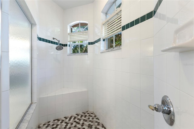 bathroom with a tile shower