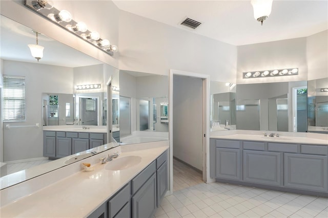 5211 Karlsburg Pl, Palm Harbor, FL 34685 - full bathroom featuring two vanities and tile patterned floors