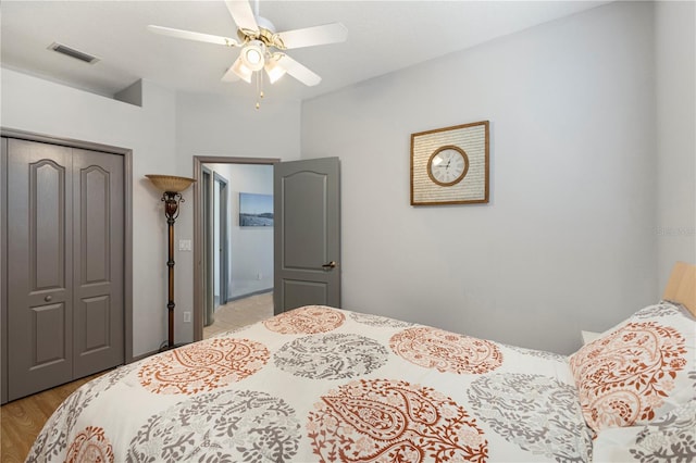 bedroom featuring ceiling fan, light wood-type flooring, and a closet