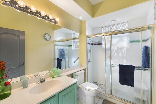 bathroom with tile patterned flooring, vanity, toilet, and walk in shower