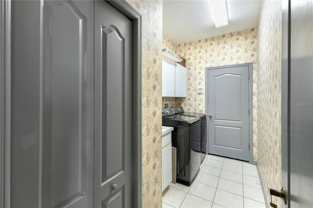 5211 Karlsburg Pl, Palm Harbor, FL 34685 - washroom featuring cabinet space, washer and dryer, light tile patterned floors, and wallpapered walls