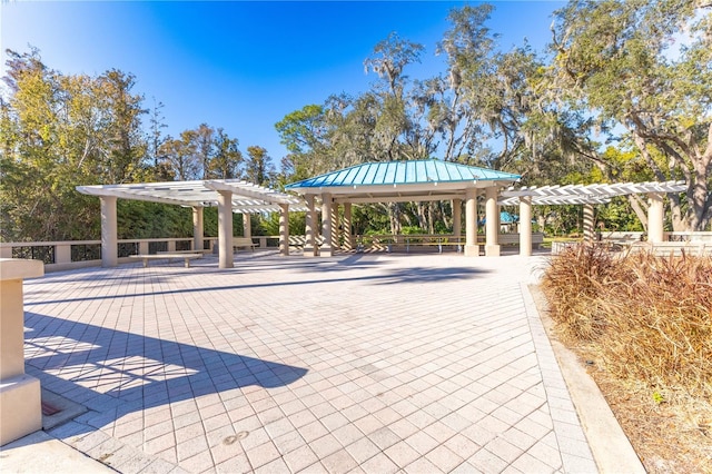 view of community featuring a pergola and a gazebo