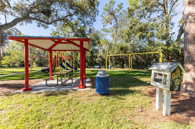 view of property's community with a lawn and a playground