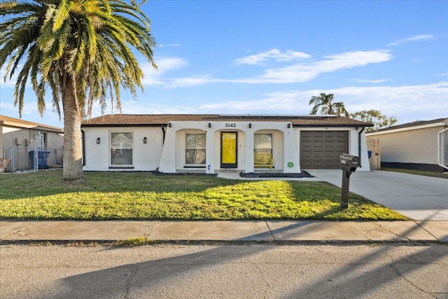 view of front facade featuring a front yard and a garage