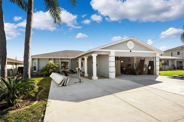 13610 Evelane Dr, Hudson, FL 34667 - view of front facade with stucco siding, an attached garage, and driveway