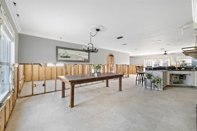 playroom featuring ceiling fan with notable chandelier and ornamental molding