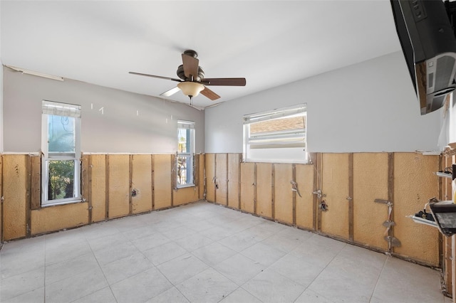 13610 Evelane Dr, Hudson, FL 34667 - spare room with a wainscoted wall and a ceiling fan