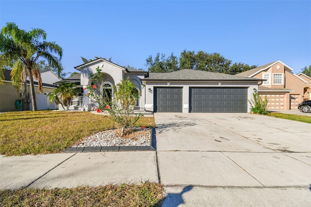 view of front facade featuring a front yard and a garage