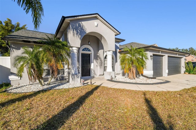 view of front of home with a front yard and a garage