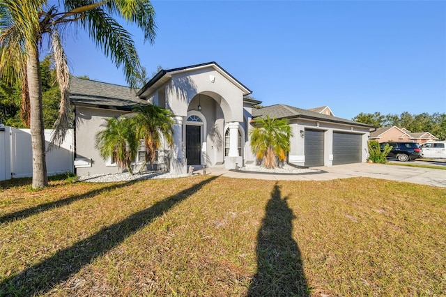 view of front facade with a front yard and a garage