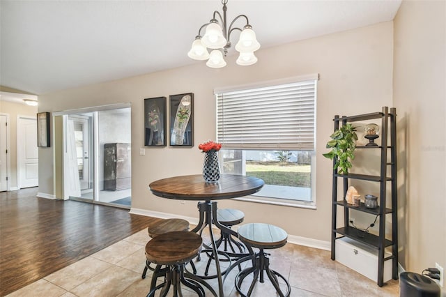 dining area featuring light wood-type flooring and a chandelier