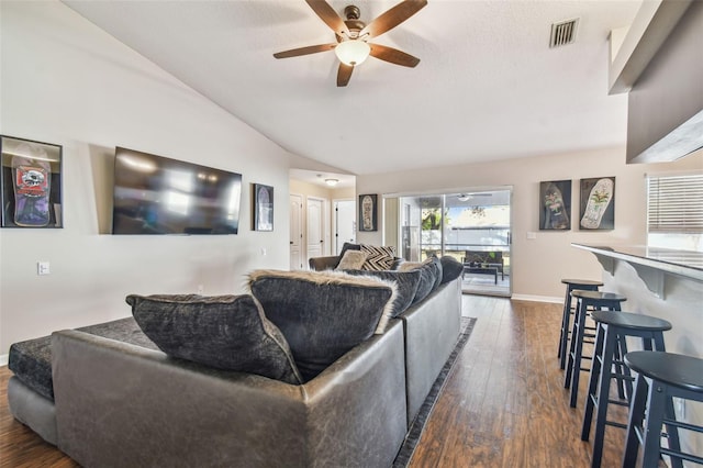 living room featuring dark hardwood / wood-style floors, ceiling fan, and lofted ceiling