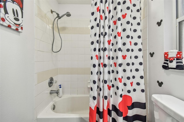 bathroom featuring shower / bath combination with curtain and toilet