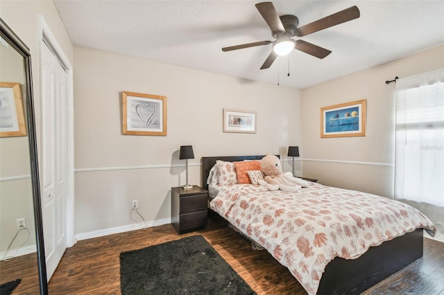 bedroom with dark hardwood / wood-style flooring, a closet, and ceiling fan