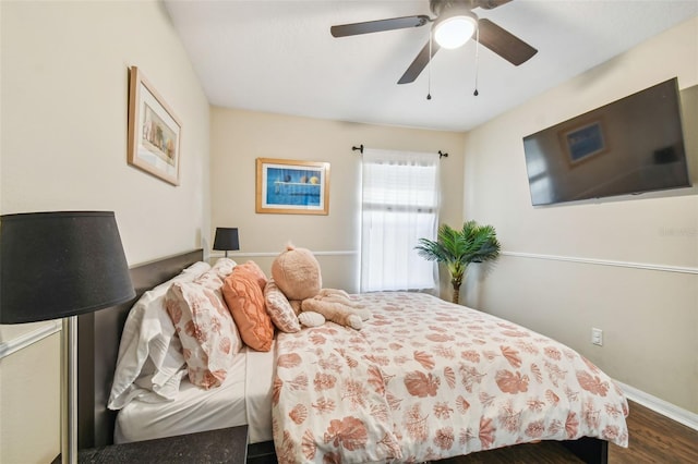 bedroom with ceiling fan and dark wood-type flooring