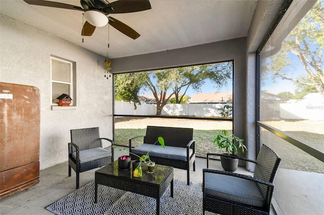 sunroom featuring ceiling fan