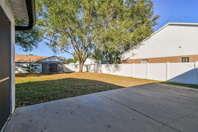 view of yard featuring a shed and a patio