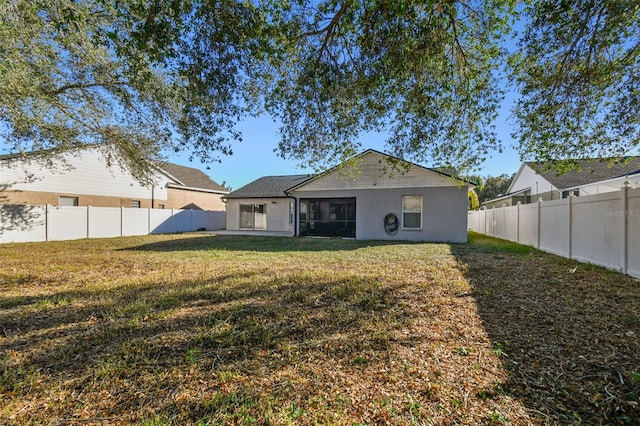 rear view of house with a yard