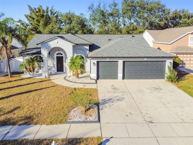 view of front of home featuring a garage and a front yard