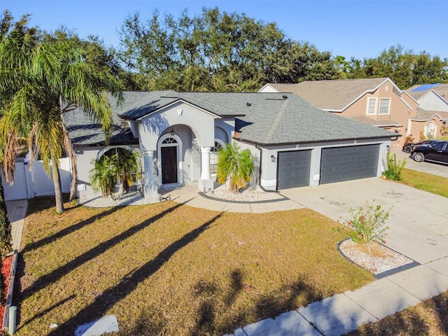 view of front of house with a front lawn and a garage