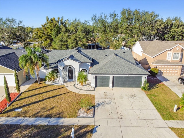 view of front of property featuring a garage and a front lawn