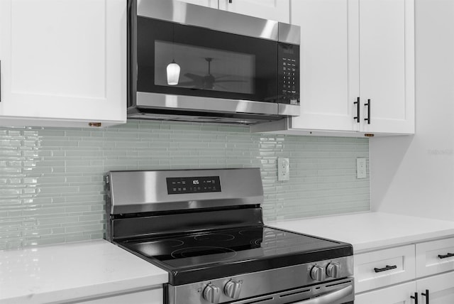 kitchen featuring appliances with stainless steel finishes and white cabinetry