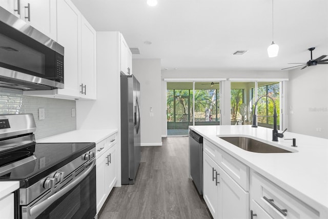 kitchen featuring white cabinets, ceiling fan, sink, and appliances with stainless steel finishes