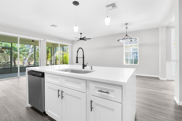 kitchen featuring sink, hanging light fixtures, stainless steel dishwasher, a kitchen island with sink, and white cabinets