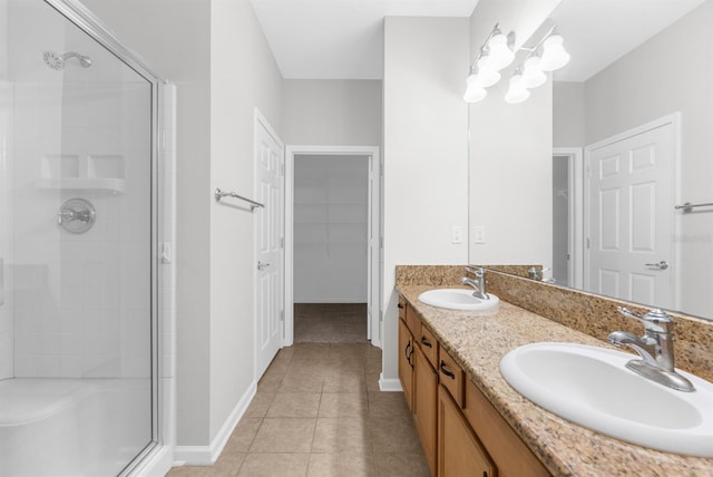 bathroom featuring vanity, tile patterned floors, and a shower with shower door