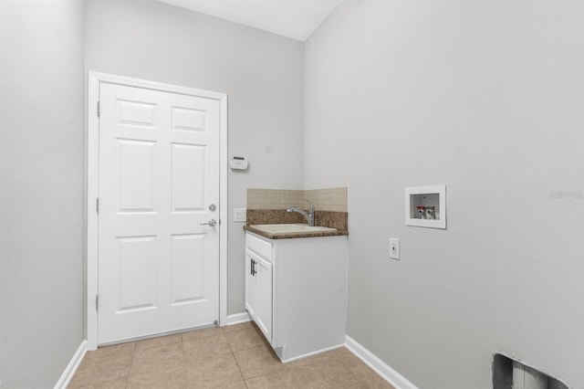 laundry room with cabinets, hookup for a washing machine, light tile patterned floors, and sink