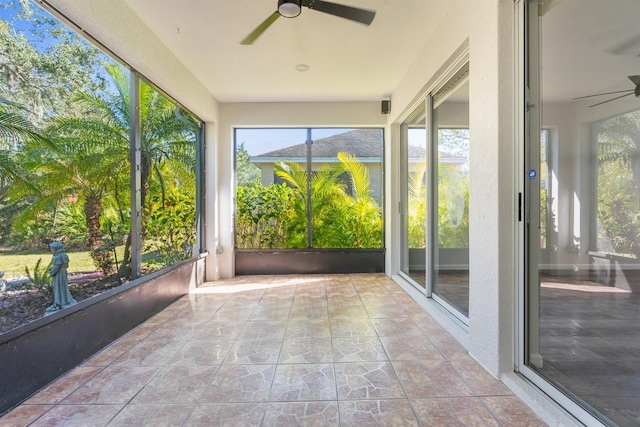 unfurnished sunroom featuring ceiling fan