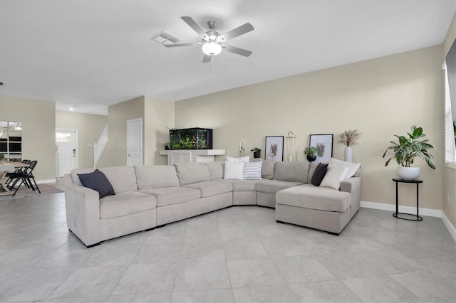 living room featuring ceiling fan and light tile patterned floors