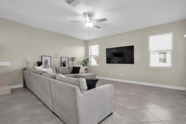 tiled living room featuring plenty of natural light and ceiling fan