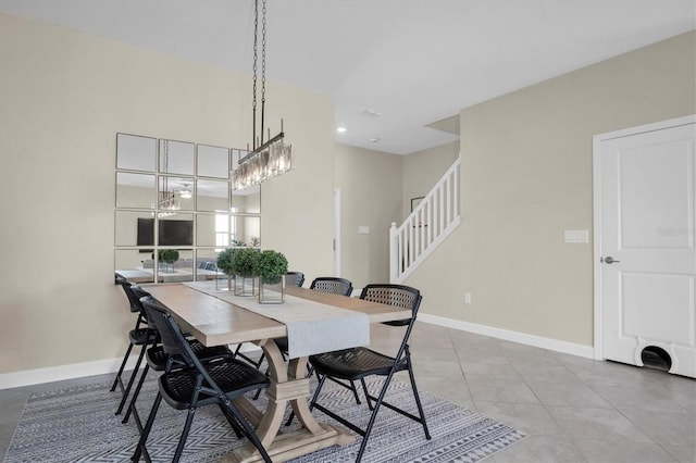 tiled dining space with a notable chandelier