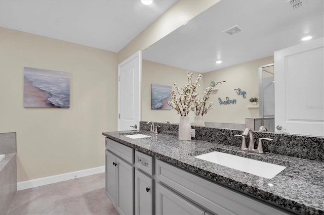 bathroom with vanity and a shower with door