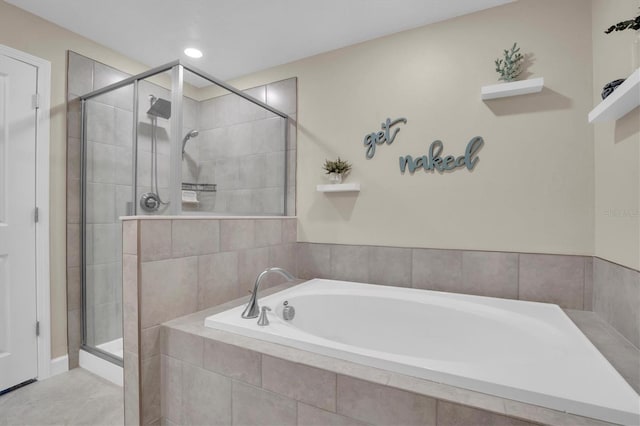 bathroom featuring tile patterned floors and separate shower and tub