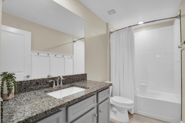 full bathroom with tile patterned floors, shower / tub combo with curtain, vanity, and toilet