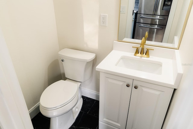 bathroom with tile patterned floors, vanity, and toilet