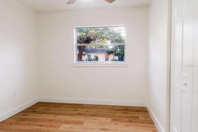 empty room with light wood-type flooring and ceiling fan