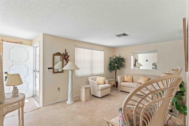 living room with light carpet and a textured ceiling