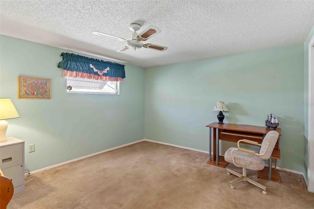 office space featuring ceiling fan, light colored carpet, and a textured ceiling