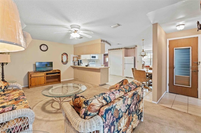 carpeted living room with ceiling fan and a textured ceiling