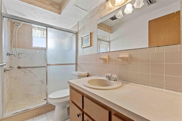 bathroom with tile patterned flooring, a shower with door, tile walls, and toilet