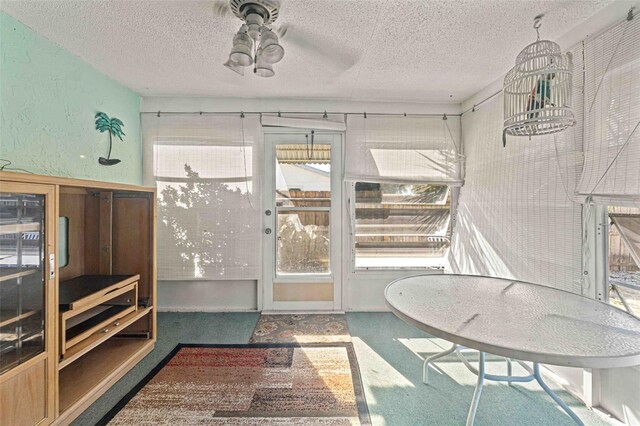 sunroom featuring ceiling fan