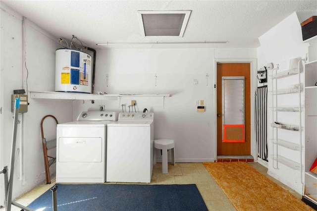 laundry room with separate washer and dryer, electric water heater, and a textured ceiling