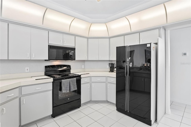 kitchen with black appliances, white cabinets, and light tile patterned floors