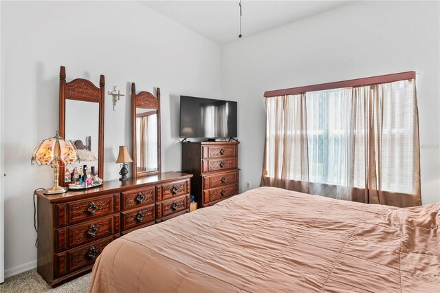 bedroom featuring light carpet