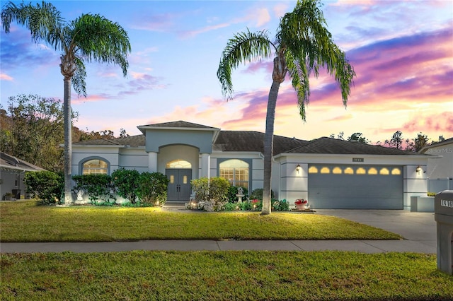 view of front facade featuring a garage and a lawn